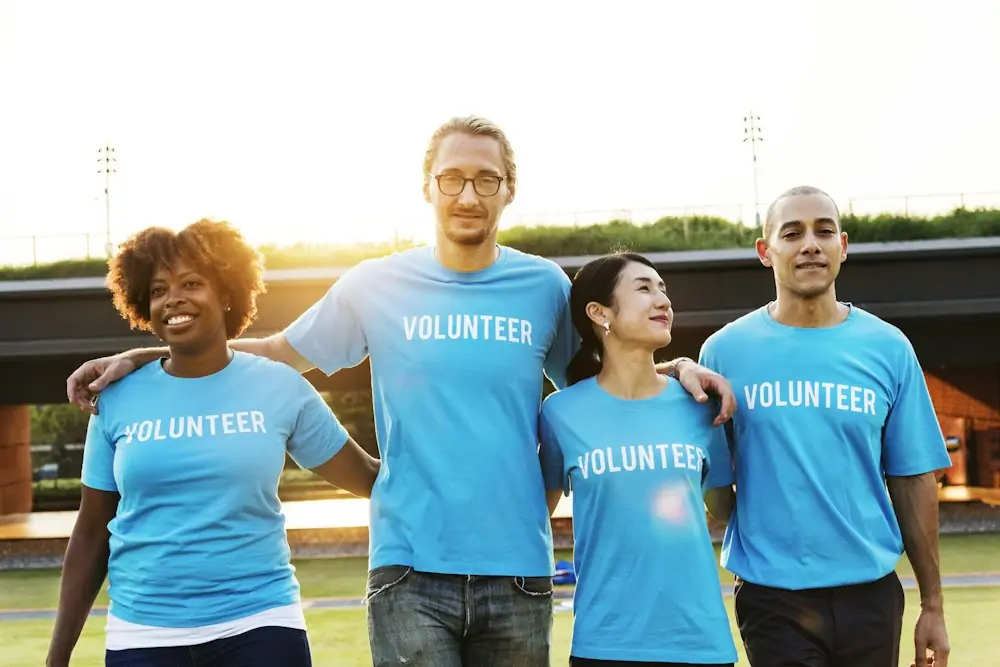 two men and women wearing blue volunteer-printed crew-neck t-shirts